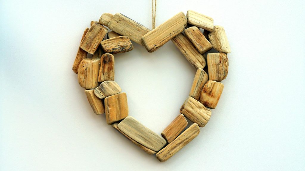 Heart-shaped craft made from rustic wooden pieces, symbolizing love and nature.