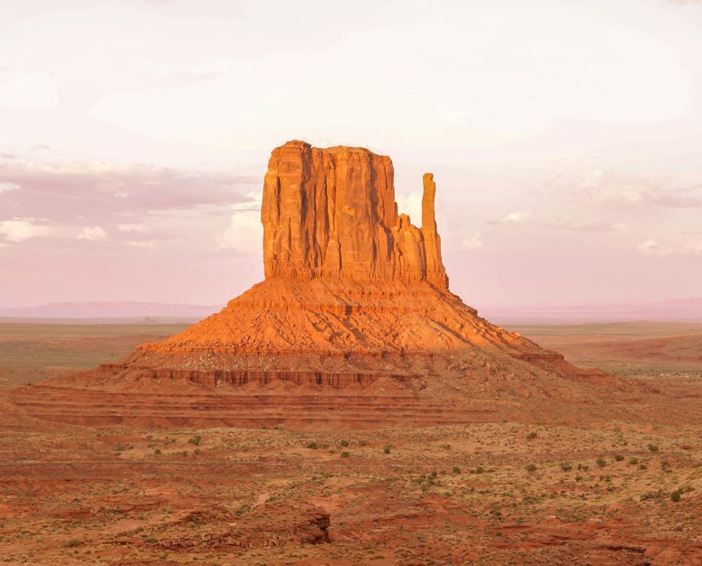 Beautiful sunrise at Monument Valley, Arizona capturing a striking red sandstone formation.