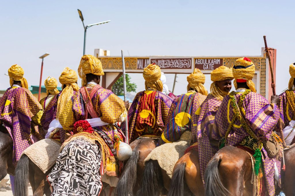 A colorful display of tradition as men in ornate attire ride horses through Abdulkarim Gate.