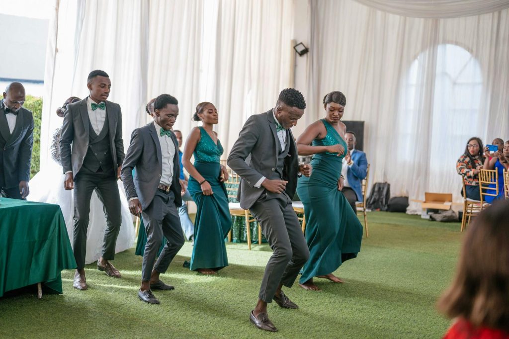 Captivating scene of wedding guests energetically dancing in formal attire.