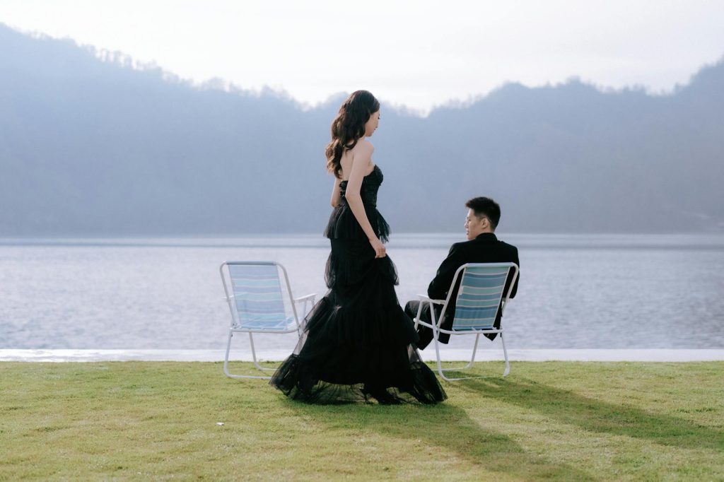 Elegant couple portrait by a serene lake in Bali, perfect for weddings and romantic themes.