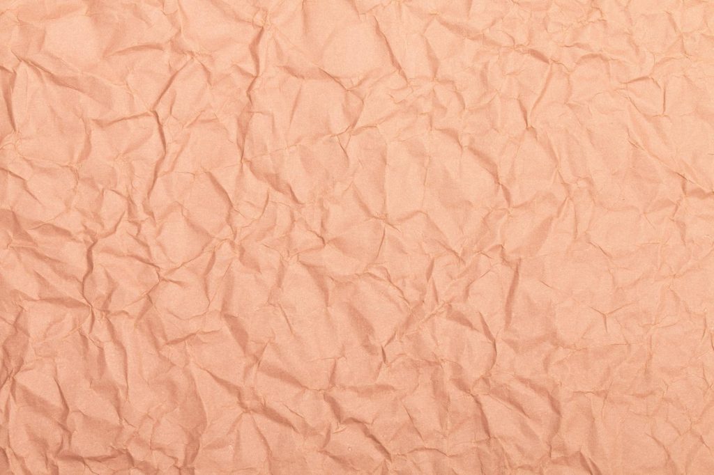 Abstract image of crumpled brown paper, perfect for background or texture use.