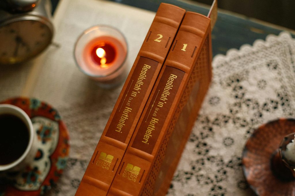 Warm and inviting reading nook with books and a softly glowing candle.