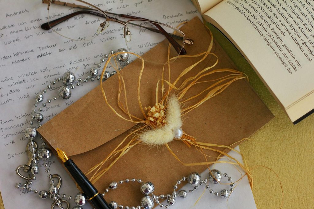 Charming flat lay of a decorative envelope, letter, and accessories for a personalized gift or correspondence.